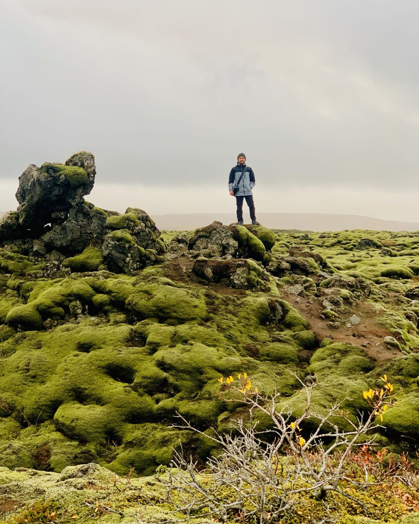 Juan José standing on a moss-covered lava field in Iceland under an overcast sky.